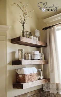 some shelves in a bathroom with towels and other items on top of them, next to a window