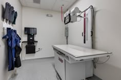 an empty hospital room with medical equipment on the wall