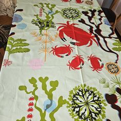 the table cloth has crabs and seaweed on it