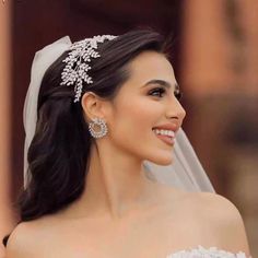 a woman in a wedding dress wearing a tiara