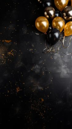 black and gold balloons on a dark background