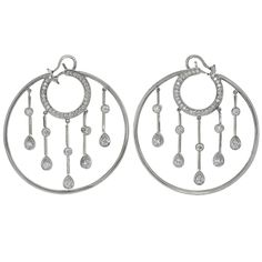 These gorgeous hoop earrings from the La Pluie collection by Chanel feature a circular design accented with dangling drops and are set with brilliant-cut round diamonds of an estimated 1.15 carats in 18k white gold. The custom-made post clips were done by Chanel as a special order. Made in France circa 2010s. Measurements: 1.88" (48mm) width, 1.96" (50mm) length. The estimated retail price is $15300. Modern Hoop Earrings, White Hoop Earrings, White Gold Hoop Earrings, White Diamond Earrings, White Gold Hoops, Circular Design, White Gold Jewelry, Classic Jewelry, Diamond Hoop Earrings