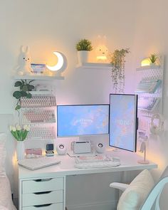 a white desk topped with two computer monitors