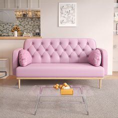 a living room with a pink couch and coffee table