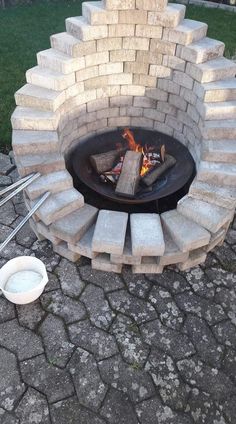 an outdoor fire pit made out of bricks