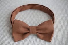 This trendy and stylish bow tie is great for so many occasions!Bow tie made of 100% cotton with a matching, adjustable neck strap. Style:• The Pre-Tied Bow Tie• The Clip-On Bow TieAll our bow ties can be made in the following sizes, just specify which size you need in a note at checkout: Sizes:Baby: 3.5" x 2"Kids: 4" x 2"Youth:  4.25" x 2.25Adult: 5" x 2.5"All our bow ties are made by hand; therefore, measurements are a guideline only and cannot be guaranteed. Neck strap sizes:Baby – adjustable Peach Bow Tie, Groom Bow Tie, Brown Bow Tie, Groom Bowtie, Groomsmen Bowtie, Green Bow Tie, Fall Bows, Kids Bow Ties, Brown Wedding