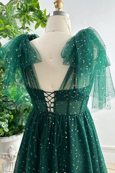 a green dress with gold stars on it