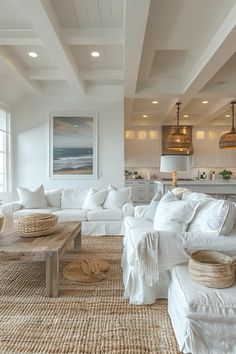 a living room filled with white furniture and lots of pillows on top of it's couches