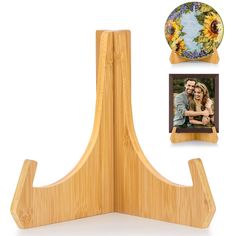 a wooden stand with two pictures and a plate on it