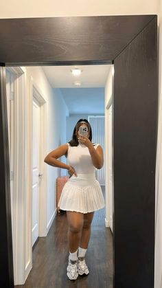 Workout outfit, tennis skirt, all white outfit, new balance, sneakers, gym outfit,   Follow my shop @simplysashafierce on the @shop.LTK app to shop this post and get my exclusive app-only content!  #liketkit #LTKSeasonal #LTKfitness #LTKfindsunder50 @shop.ltk https://liketk.it/4zc41 Athletic Outfits Skirt, Tennis Skirt Set, All White Tennis Skirt Outfit, White Skirt Sneakers Outfit, Fitness Skirt Outfits, Outfit Skirt Ideas, Outfit Ideas White Skirt, Cute All White Outfits, White Outfit Skirt