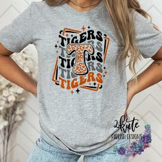 Treat yourself or anyone in your life to this awesome School pride tshirt. It's a Tiger thing.  Great for all occasions.  And great for supporting your Tigers team.  Shirt is made of 95% polyester and 5% spandex. It is soft with great stretch. It is a unisex style shirt.   To get the best wear from your shirt please  1. Wash with mild detergent  2. Do not use fabric softener  3. Do not use bleach 4. Tumble dry low.  Please enjoy your shirt as I know we have enjoyed all the ones we have made for ourselves!! Please note that every shirt is made to order and normal processing time takes us 3-5 business days to create a shirt and ship out an order; however, we strive our very best to get it out sooner!  *some shirts are made by a process called sublimation printing. It is normal if you see som Tiger Pride Shirts, Collegiate T-shirt With Custom Print For Game Day, Tiger Mascot Shirt Ideas, School Spirit T-shirt For Cheerleading In Fall, Varsity T-shirt With Custom Print For Game Day, Fall School Spirit T-shirt With Text Print, School Spirit Text Print T-shirt For Fall, School Spirit T-shirt For Fall Season, Custom Print School Spirit Tops For Fan Gear