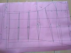 a piece of pink paper with lines drawn on it