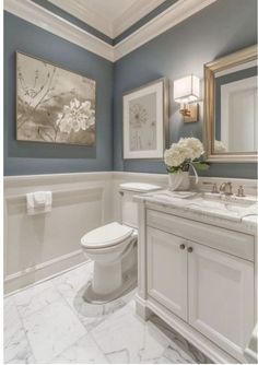 a bathroom with blue walls and white fixtures