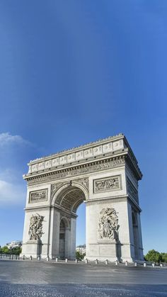 the arc de trioe triumph in paris, france on a sunny day with blue skies