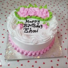 a birthday cake with white frosting and pink flowers