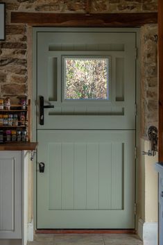 a green door with a small window in it