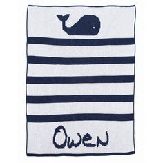 a blue and white blanket with a whale on it's side that says, queen