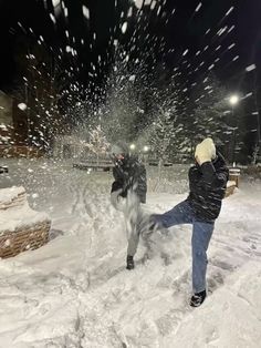 a man is throwing snow at a horse