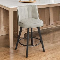 a white counter top sitting next to a bar stool