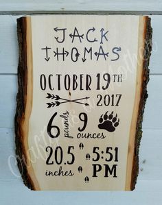 a wooden sign with the date and birth dates on it, hanging on a wall