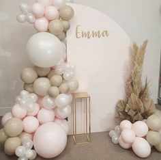 there are balloons on the floor and in front of a sign that says emuna