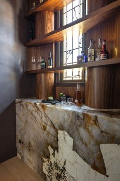 a marble counter top in a bar with bottles on it