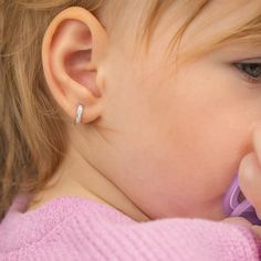 Add some sparkle to your little girls outfits with this beautiful pair of huggie hoop earrings. An extra small pair of huggies that feature beautiful clear cubic zirconia stones throughout the front of the huggie. This fun pair of huggie hoops can be paired with your little one special occasion outfits or can be worn on a regular basis. Created from 14k white gold, these little huggie hoops arrived neatly packaged into a gift box for for easy gifting. Age Group: Lovely for Girls and Preteens; Sa