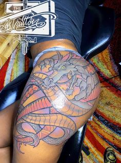 a woman with a dragon tattoo on her leg