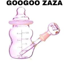 a pink glass baby bottle with a measuring cup attached to the top and handle, labeled googoo zaza