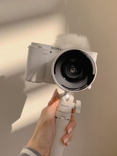 a person holding a camera up to the ceiling