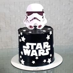 a black and white cake with a star wars theme on it