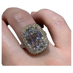 a woman's hand with a fancy ring on it