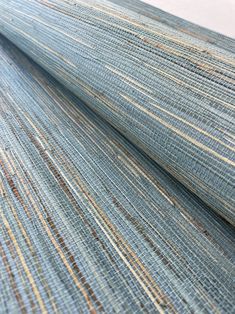 a close up view of a blue and tan striped wallpaper