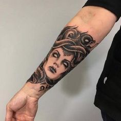 a woman's arm with a tattoo on it and an octopus in the background