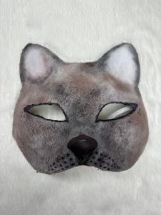 This is one of my newer masks, a siamese cat! It is a high quality mask made from a cat mask base.  Mask Features: * Designed with eyeshadow for an airbrushed look * Clay nose add on * Felted Note: This product is made with a paper base, and therefore will mold if it gets wet and not dried properly. Please be careful not to bring this product near water! If you have any questions, feel free to reach out! Cat Design Eye Mask For Masquerade, Masquerade Eye Mask With Cat Design, Masquerade Mask With Whiskers, Cat Ears Masks With Whiskers For Masquerade, Cat Design Eye Mask For Costume Party, Masquerade Cat Ears Mask With Whiskers, Cat Design Eye Mask For Costume, Cat Design Costume Eye Mask, Costume Cat Design Eye Mask