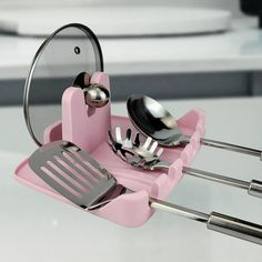 a pink utensil holder with spoons and spatulas