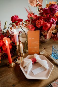 the table is set with flowers and candles