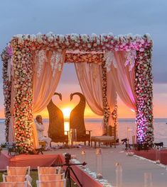 an outdoor wedding setup with two swans in the middle