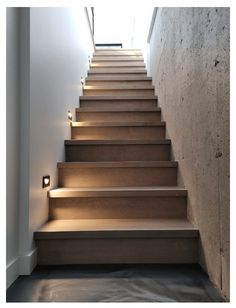 there is a set of stairs leading up to the second floor with lights on each step