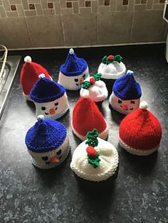 knitted snowman cupcakes are sitting on the counter in front of the oven