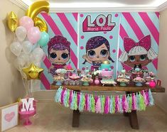 a table topped with lots of cupcakes and cake next to balloons in front of a wall