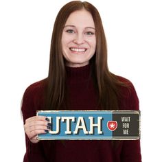 a woman holding up a sign that says kentucky