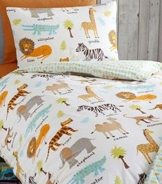 a bed with an animal themed comforter and matching pillow cases on top of it