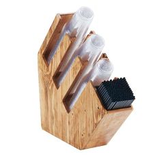 a wooden holder with four different types of hair brushes