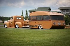 an orange and brown bus parked in front of a house