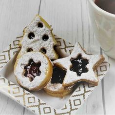 two pastries on a plate next to a cup of coffee