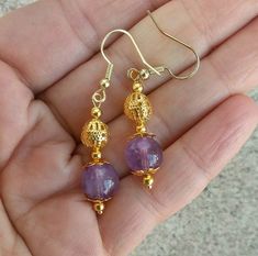 These earrings are made with rich, purple amethyst stone and gold plated filigree findings. Drops are 12mm long, and hang from fish hook earwires. Earrings are handmade to order. Gift wrap is available! Handmade Amethyst Gold Earrings, Gold Amethyst Earrings With Ear Wire, Handmade Gold Amethyst Earrings, Pride Necklace, Rich Purple, Sterling Silver Dangle Earrings, Silver Chain Necklace, Drop Necklace, Silver Earrings Dangle