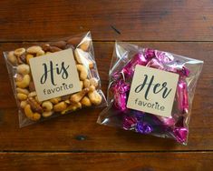 two bags filled with nuts and chocolates on top of a wooden table next to each other