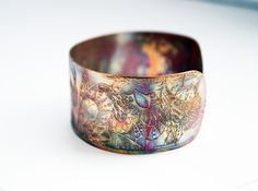 This etched copper bangle bearing imagery of owls, has been heat treated to create a vibrant multicoloured patina: this will deepen over time. I have developed a technique of literally 'painting' with a flame to manipulate the shape and direction of the colours. Although there is a degree of control, each piece is unique, as the colour patina cannot be replicated exactly. In holistic medicine, copper claims to have many health benefits: 'Copper has been used to promote health in various ways sin Artistic Patina Cuff Bracelet As Gift, Artistic Patina Cuff Bracelet Gift, Artistic Patina Bangle Bracelet, Barn Owls, Eye Infections, Etched Copper, Deep Autumn, Valentines Sale, Holistic Medicine