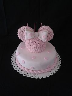 a minnie mouse cake with pink icing and polka dots